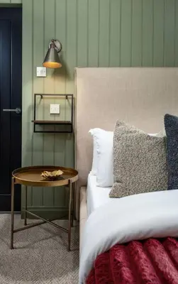 a bedroom with a bed and a table next to a bed at The Braveheart Suite by The Wallace Monument in Stirling