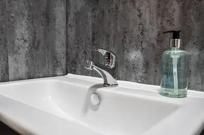 a bathroom sink with a soap bottle on it at The Braveheart Suite by The Wallace Monument in Stirling