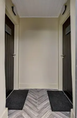 a hallway with two doors and a tiled floor at The Braveheart Suite by The Wallace Monument in Stirling
