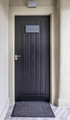 a black door of a building with a sign on it at The Braveheart Suite by The Wallace Monument in Stirling
