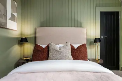 a bedroom with a large bed with pillows at The Wallace Suite by The Wallace Monument in Stirling