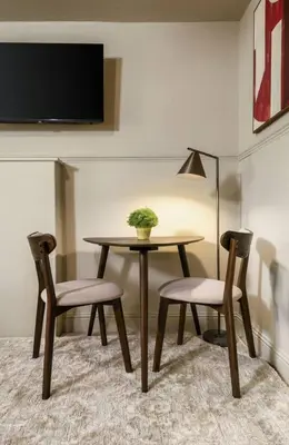 a table and two chairs and a table with a plant on it at The Wallace Suite by The Wallace Monument in Stirling