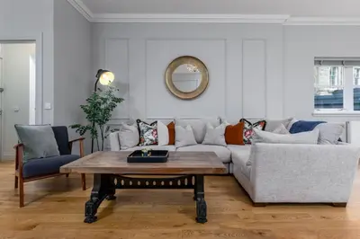 a living room with a couch and a table at Kings Park Garden Cottage - Free Parking in Stirling