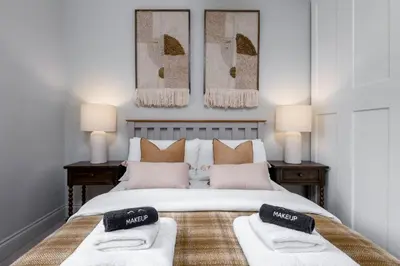a bedroom with a large white bed with two pillows at Kings Park Garden Cottage - Free Parking in Stirling