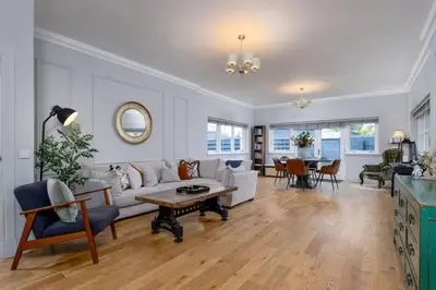a living room with a couch and a table at Kings Park Garden Cottage - Free Parking in Stirling