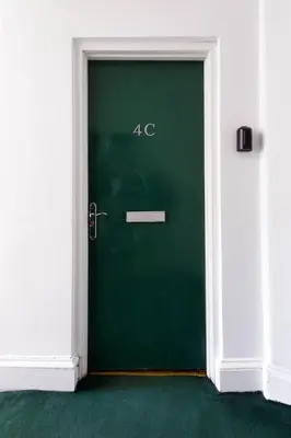 a green door with the number on it at Elegant 3 Bed Apartment in Stirling Near Free Parking and Hill Views in Stirling