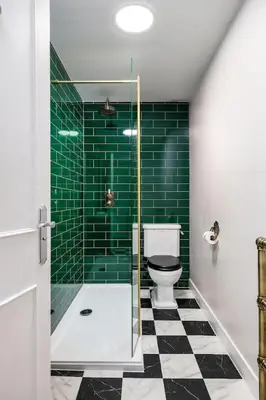 a bathroom with a shower and a toilet and green tiles at Elegant 3 Bed Apartment in Stirling Near Free Parking and Hill Views in Stirling