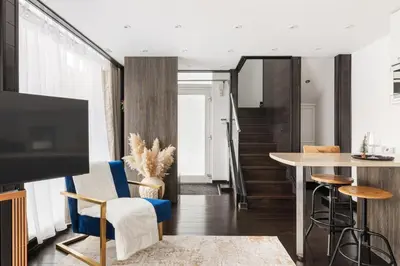 a living room with a tv and a table at New! Modern Wapping 1BR Flat near Tower Bridge in Moffat