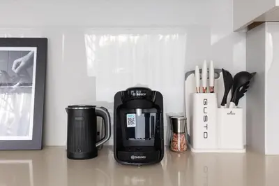 a coffee maker sitting on a counter next to a coffee mug at New! Modern Wapping 1BR Flat near Tower Bridge in Moffat