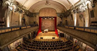 an empty theatre with a red curtain and a stage at New! Modern Wapping 1BR Flat near Tower Bridge in Moffat
