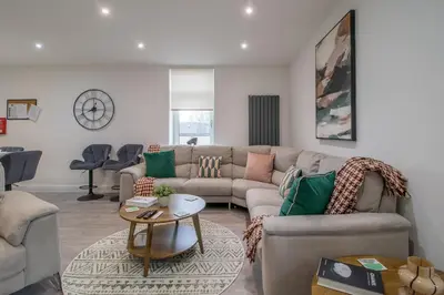 a living room with a couch and a table at William Wallace View - 5 Bedrooms in Stirling in Stirling