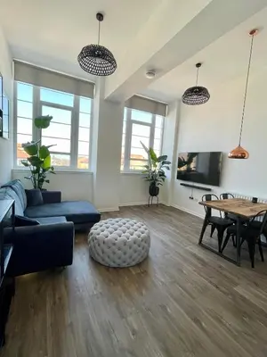 a living room with a couch and a table at WHITE LOFT - Modern flat close to the City Centre in Edinburgh