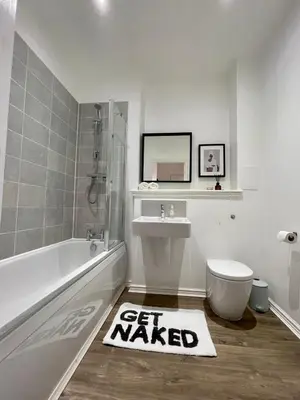a bathroom with a tub and a toilet and a sink at WHITE LOFT - Modern flat close to the City Centre in Edinburgh