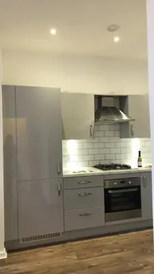 a kitchen with stainless steel appliances and a stove at WHITE LOFT - Modern flat close to the City Centre in Edinburgh