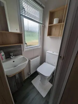a small bathroom with a toilet and a sink at Swift Bordeaux Sea View No 2 in Dunoon