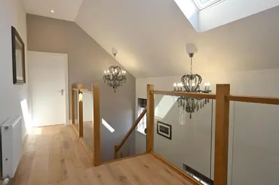 a hallway with a chandelier in a house at Kennels Cottage in Buchanty