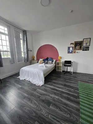 a bedroom with a bed and a desk in it at #127 Modern City Suite Digbeth Creative Quarter in Moffat