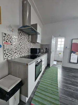 a kitchen with a green rug on the floor at #127 Modern City Suite Digbeth Creative Quarter in Moffat