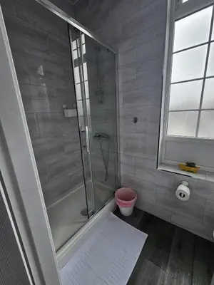 a shower with a glass door in a bathroom at #127 Modern City Suite Digbeth Creative Quarter in Moffat