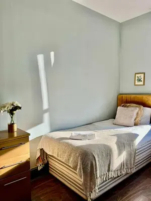 a bedroom with a bed and a dresser in a room at Lovely Apartment by Meadows 1 in Edinburgh
