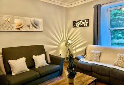 a living room with a couch and a chair at Lovely Apartment by Meadows 1 in Edinburgh