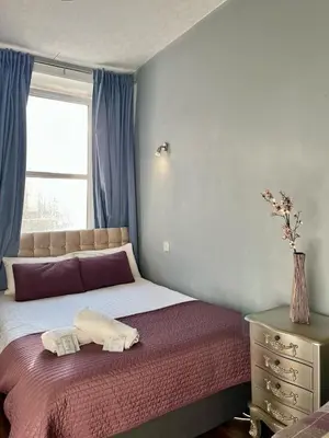 a bedroom with a bed with two towels on it at Lovely Apartment by Meadows 1 in Edinburgh