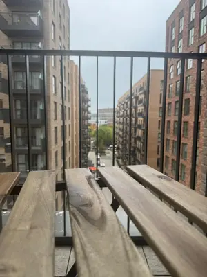 two wooden benches on a balcony in a city at Colindale Condominium in Moffat