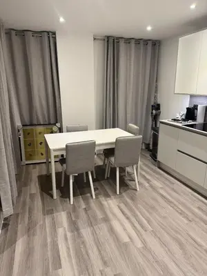 a kitchen with a table and chairs in a room at Colindale Condominium in Moffat