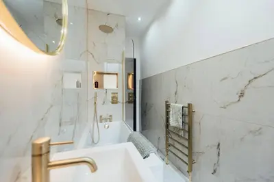 a white bathroom with a tub and a sink at Sea View, 2 Bed Apartment, Central Largs in Largs