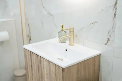 a bathroom sink with a soap bottle on top of it at Sea View, 2 Bed Apartment, Central Largs in Largs
