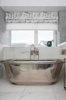 a bath tub in a bathroom with a window at Stylish Retreat Auchterarder in Auchterarder