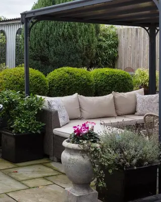 a couch under a pergola in a garden at Stylish Retreat Auchterarder in Auchterarder