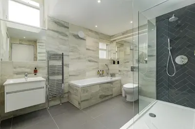 a bathroom with a tub and a sink and a toilet at Destiny Scotland - Princes Street Residence in Edinburgh
