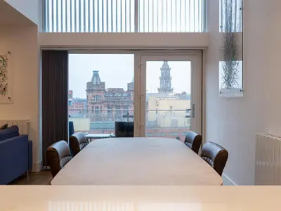 a conference room with a large table and a large window at CITY CENTRE APARTMENT with Free Secure Underground Parking in Glasgow