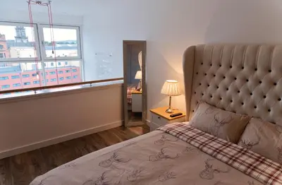 a bedroom with a large bed and a window at CITY CENTRE APARTMENT with Free Secure Underground Parking in Glasgow