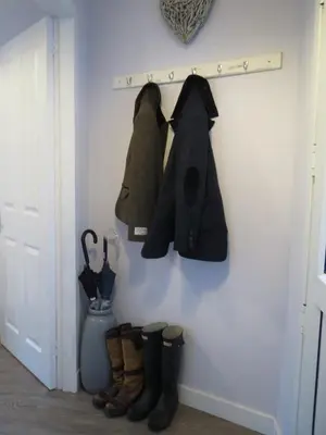 a room with a door with coats and boots at Elmbank Garden Apartment in Oban
