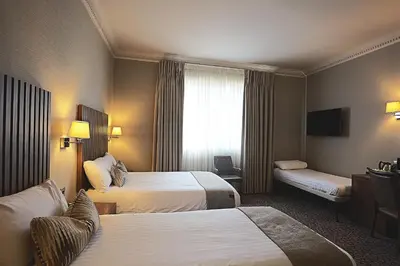 a hotel room with two beds and a window at Frederick House Hotel in Edinburgh