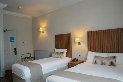 a hotel room with two beds and a telephone at Frederick House Hotel in Edinburgh