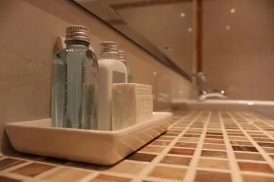 two bottles of water sitting in a holder in a bathroom at The Grange Manor in Grangemouth