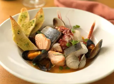 a plate of food with seafood on a table at The Isles of Glencoe Hotel in Glencoe