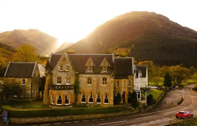 a large house in front of a mountain at The Ballachulish Hotel in Glencoe