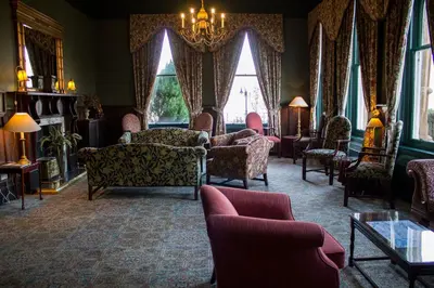a living room filled with furniture and a chandelier at The Ballachulish Hotel in Glencoe