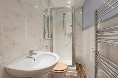 a white bathroom with a sink and a toilet at Rose Street Residence in Edinburgh