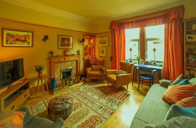 a living room with a couch and a fireplace at Dana Villa Holiday Accommodation in Oban
