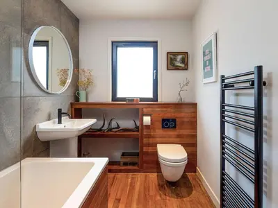 a bathroom with a sink toilet and a mirror at Carsaig in Port of Menteith