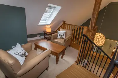 a living room with a couch and a table at Butt Lodge in Lochranza