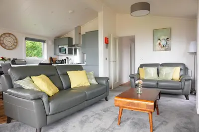 a living room with a couch and a table at Linwater Caravan Park - Luxury Lodges and Static Caravans near Edinburgh in Newbridge