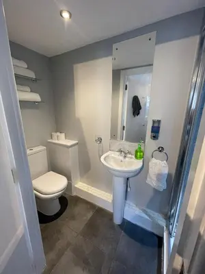 a bathroom with a toilet and a sink at Black Bull with Rooms upper in Cumbernauld