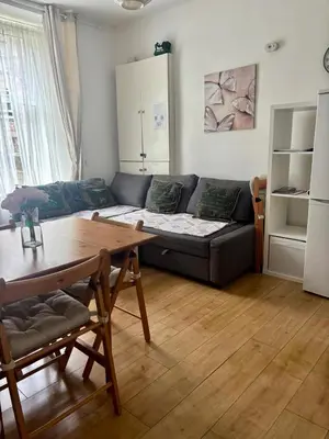 a living room with a couch and a table at Edinburgh Central Apartment in Edinburgh