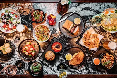 a table with many plates of food on it at Dakota Glasgow in Glasgow